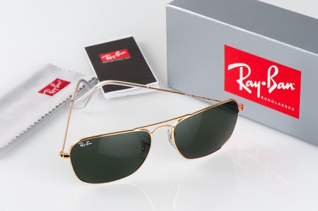BANGKOK, THAILAND - AUGUST 23, 2016: The Ray-Ban Caravan with gold frame and classic G-15 Lens. Ray-Ban is a brand of sunglasses and eyeglasses founded in 1937 by American company Bausch & Lomb.のeditorial素材