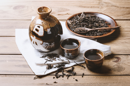 the classic brown japanese tea set on wooden table, with the word meaning Japan on the jar.の写真素材