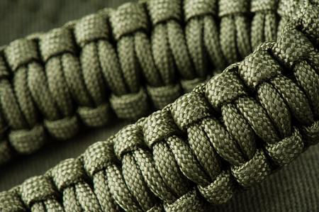 closeup braided green paracord bracelet, handmade paracord braceletの写真素材