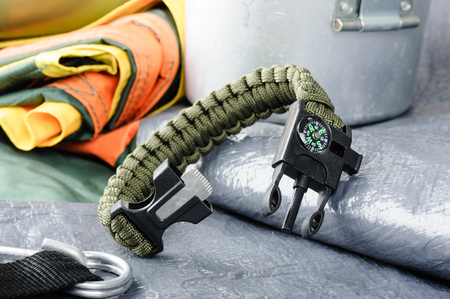 closeup green multifunction paracord survival bracelet for campingの写真素材