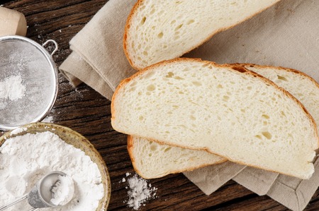 closeup fresh sliced bread on wooden tableの写真素材