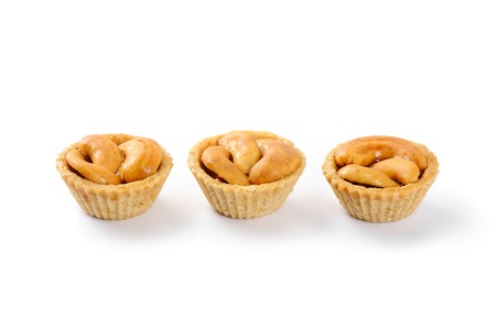 cashew nut pie, mini pie with cashew nuts on top over white backgroundの写真素材