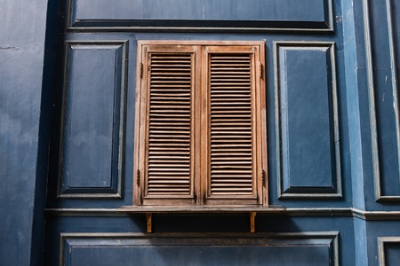 old wooden windows on blue wooden wallの写真素材