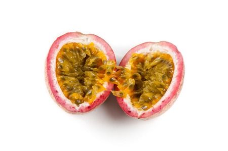 Fresh passion fruit over white background. Passion fruit contains many small black seeds covered...