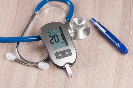 Checking blood sugar level with blood glucose meter.の写真素材