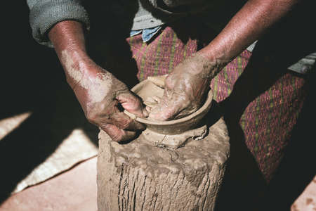 closeup old woman potter hands making bowl from clay, without potter's wheelの写真素材