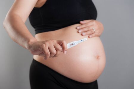 closeup pregnancy test in pregnant woman's handの写真素材