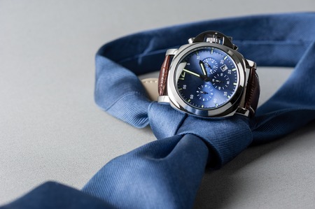 luxury fashion watch with blue dial and brown crocodile grain leather watch band