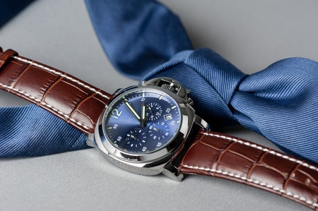 luxury fashion watch with blue dial and brown crocodile grain leather watch bandの写真素材