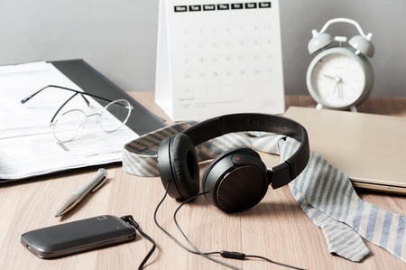 wired black headphone isolated on the desktopの写真素材