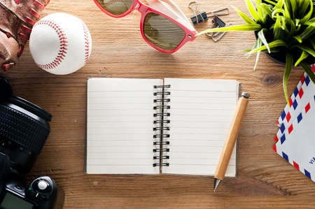 wooden desktop with blank notebook paper background