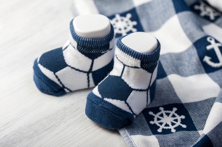 new baby socks on white wooden board, newborn and baby conceptの写真素材