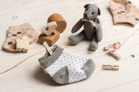 new baby socks on white wooden board, newborn and baby conceptの写真素材