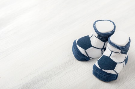 new baby socks on white wooden board, newborn and baby conceptの写真素材