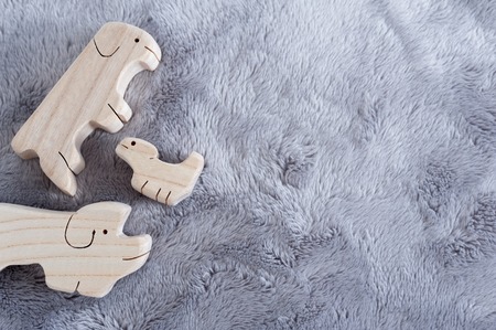 cute wooden toy animals on fluffy fabricの写真素材