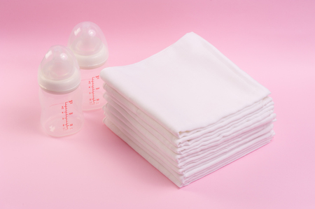 closeup white and soft baby cloth diapers over pink backgroundの写真素材