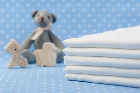 closeup white and soft baby cloth diapers over blue backgroundの写真素材