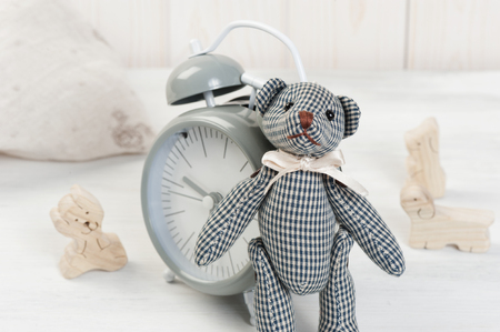Cute teddy bear on wooden background with wooden baby toysの写真素材