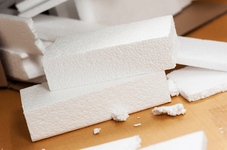 Closeup white polystyrene foam on the cardboard. Polystyrene foam is cushioning material in packaging, material for craft applications and other.の写真素材