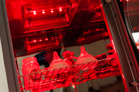 Sanitizing the baby things in UV Sterilizer and dryer, new technology for sanitize the baby things by UV Light. (Shallow depth of field)の写真素材