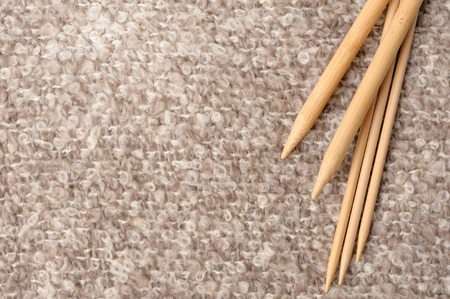 closeup bamboo knitting needles over knitted mohair, knitting concept