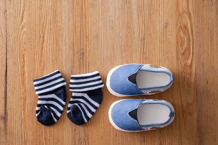 closeup little shoes for baby on wooden deskの写真素材
