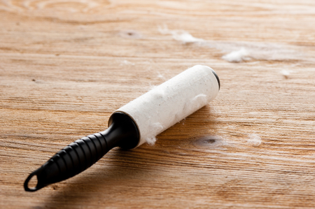 adhesive lint roller full of dust after used to clean the clothの写真素材