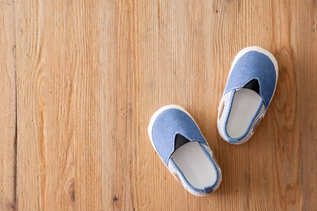 closeup little shoes for baby on wooden deskの写真素材