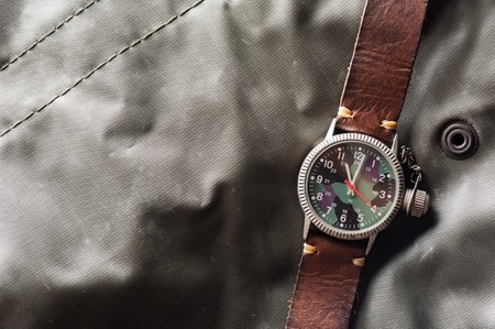 old military or field style of wristwatch with camouflage dial and leather band.の写真素材