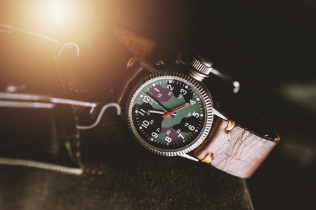 old military or field style of wristwatch with camouflage dial and leather band.の写真素材