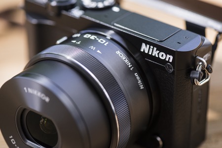 BANGKOK, THAILAND - JUNE 25, 2017: Black Nikon 1 J5 with 1 Nikkor 10-30mm attached. The Nikon 1 J5 is a digital mirrorless camera announced by Nikon on April 2, 2015.のeditorial素材