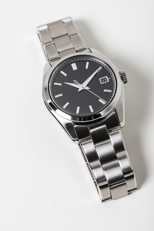 closeup luxury automatic wristwatch for men with black dial and stainless steel bracelet. Watch isolated over white backgroundの写真素材