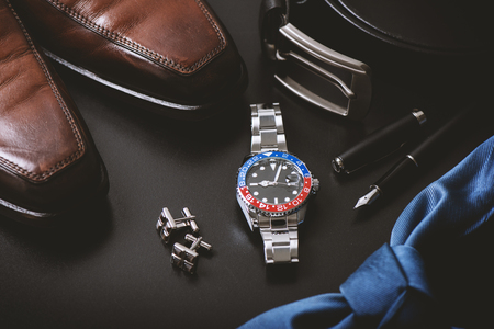 men's accessories, closeup at wristwatch with black dial blue-red bezel and stainless steel bracelet.の写真素材