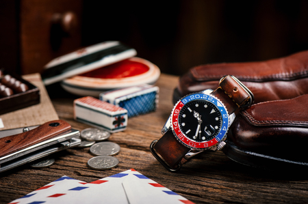 closeup luxury wristwatch for men with black dial blue-red bezel and leather strap.の写真素材