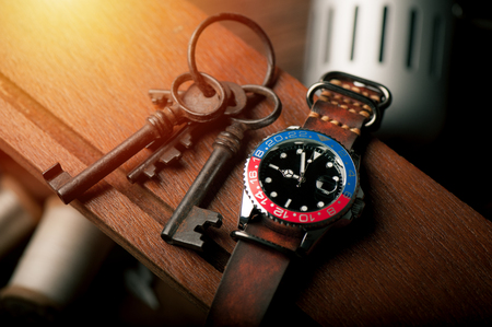 closeup luxury wristwatch for men with black dial blue-red bezel and leather strap.の写真素材