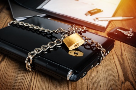 laptop with chain and padlock, computer and data security concept.の写真素材