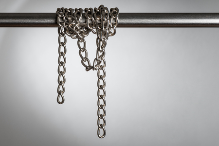 abstract stainless steel chain on the metal barの写真素材