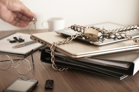 important information locked with chain and padlock, computer and data security concept.