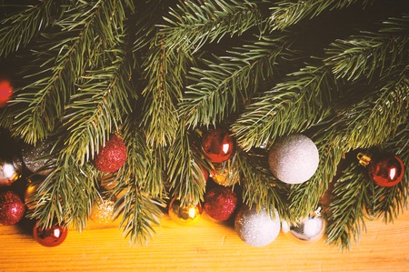 wooden background with fir tree branches and decorations, Christmas and New Year conceptの写真素材