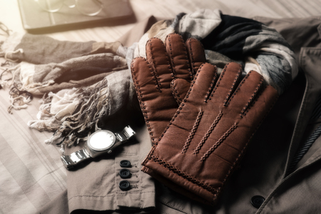 Pair of men's brown leather gloves and other men's accessories.の写真素材