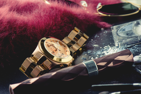 Closeup the rose gold wrist watch with cracked glass. The broken wrist watch. Concept of crime and accident.の写真素材