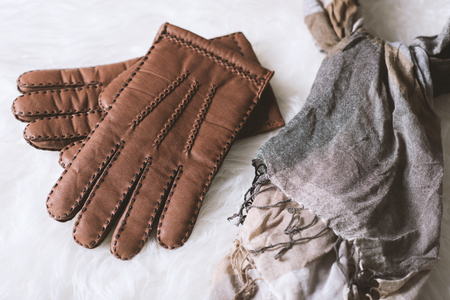 Pair of men's brown leather gloves and other men's accessories.の写真素材