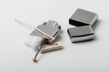 Disassembling of Lighter with windproof over white background.の写真素材