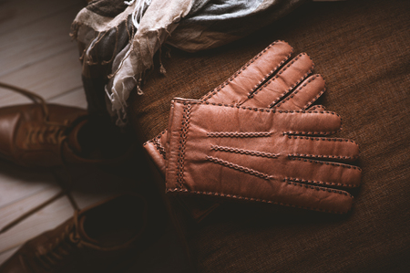 Pair of men's brown leather gloves and other men's accessories.の写真素材