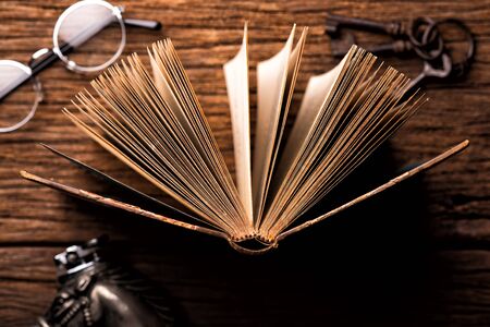 Opened vintage book on the wooden tableの写真素材