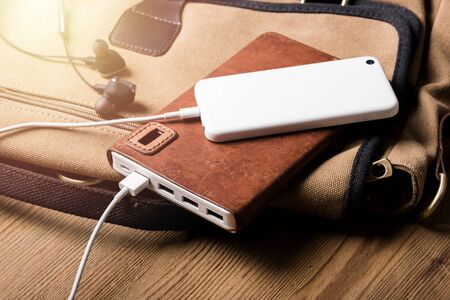 smartphone charging with white power bank. close-up at white power bank.