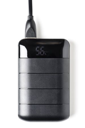 Black power bank isolated over white background. Power bank, portable device that can supply power to smartphones or other electronic devices.の写真素材