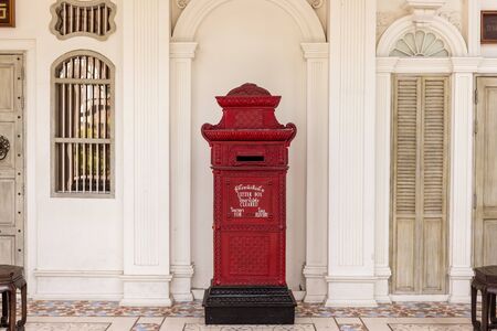 PHUKET, THAILAND - APRIL 19, 2018: Red vintage letter box in Phuket old town in Phuket province,...