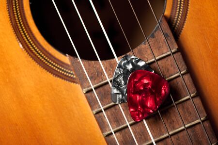 Closeup guitar pick on an old classical guitar. A guitar pick is a plectrum used for guitars.の写真素材
