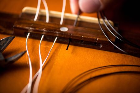Restring classical guitar concept. Closeup at the new strings.の写真素材